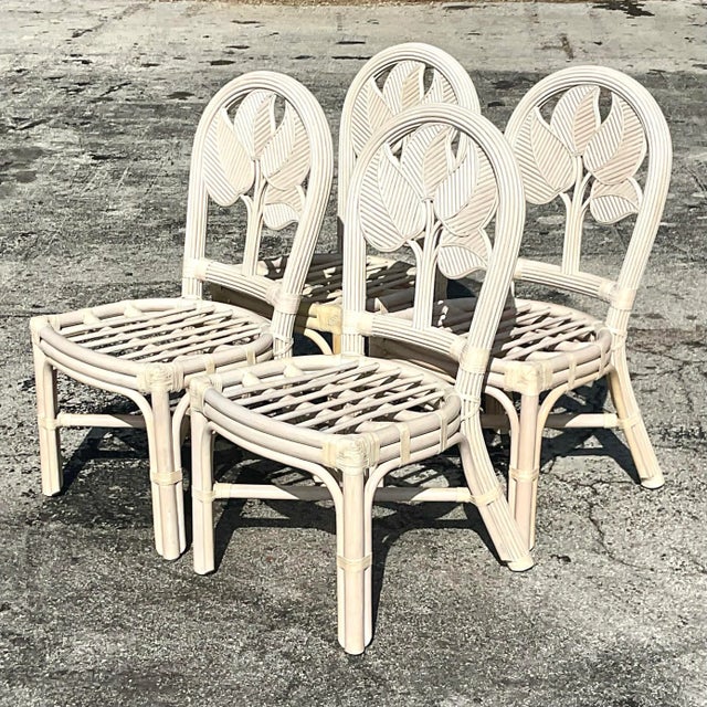 A set of four gorgeous vintage coastal rattan dining chairs. Acquired at a Palm Beach estate.