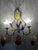 An elegant Venetian-style wall sconce, crafted from wrought iron and Murano blown glass. Its wrought iron frame forms...
