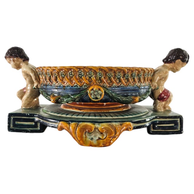 This is a reproduction of of a famous 18th century Wedgwood Bowl. It has two cherubs flanking each side and functioning as...