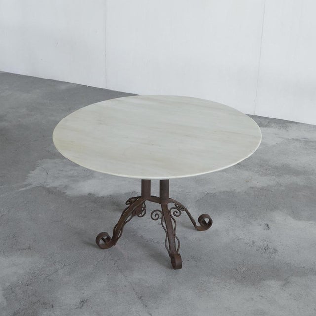 Very elegant art deco coffee table in patinated wrought iron and white marble. Europe, 1930s. This coffee table is really...