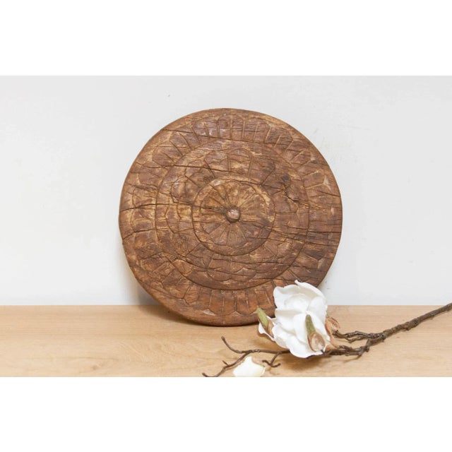 This finely carved vintage chapati plate, handcrafted from wood, brings a touch of global charm to your home. Originally...