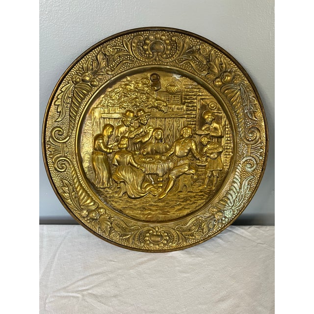 This distinguished pair of early 20th century embossed brass platters reflects the craftsmanship and narrative richness...