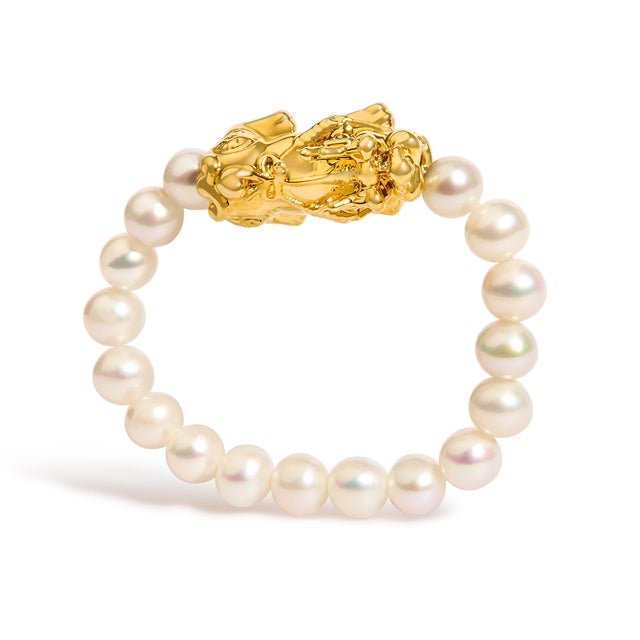 Power and poise coil at your fingertips in this sculpted talisman: a polished 18K yellow gold dragon perched above a band...
