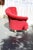 Modern Peter Shire-style lounge chair in ruby red with flared tufted back and white sabre feet.