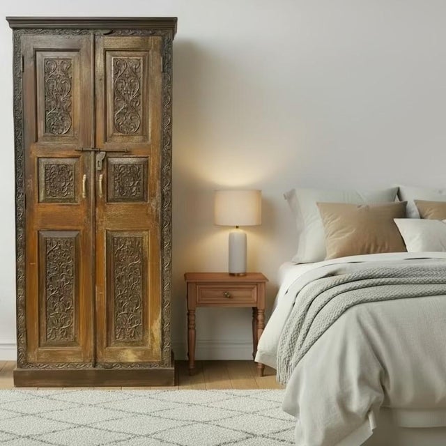 Dimensions: 41" W x 18" D x 93" H This one-of-a-kind armoire features an authentic vintage hand-carved door salvaged from...