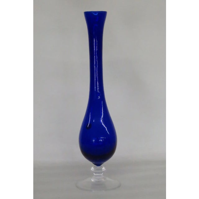 This Vase is made out of glass. This lovely vase features a classic tall silhouette, a wonderfully rich cobalt blue color...