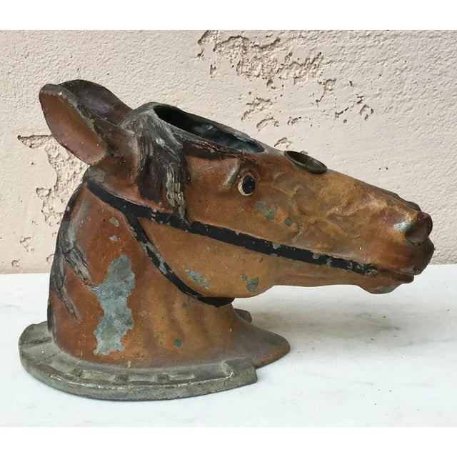 Fine metal painted head horse on horseshoe, circa 1890.