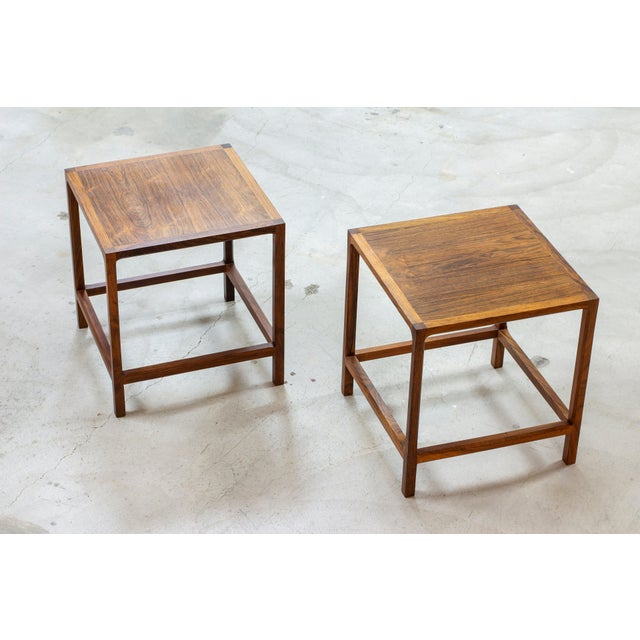A pair of side tables designed by kai kristiansen. Produced in denmark by aksel kjaersgaard during the 1950s. Made from...
