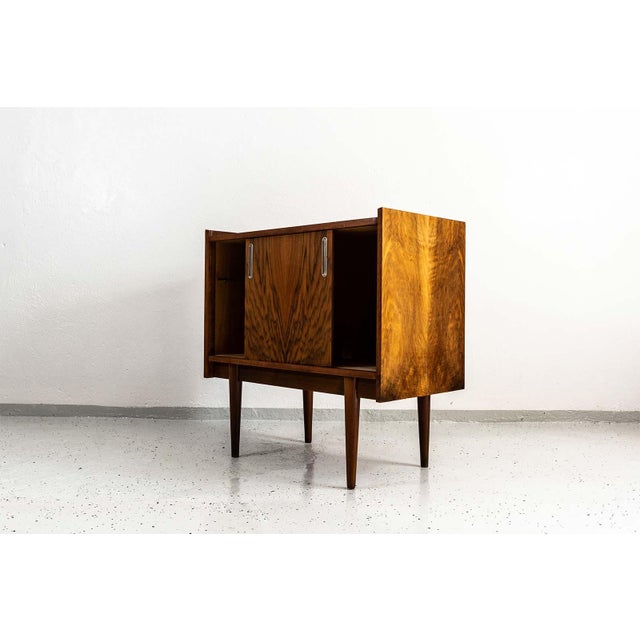This walnut-veneered dry bar was manufactured by the Bytomskie Fabryki Mebli in the 1960s. The piece is part of the...