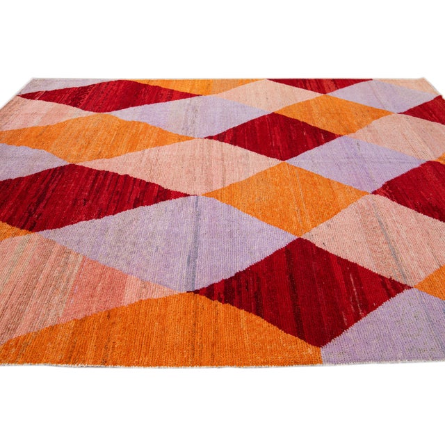 Beautiful modern Turkish wool rug with an orange, red, beige, and purple field layout in a gorgeous geometric diamond...