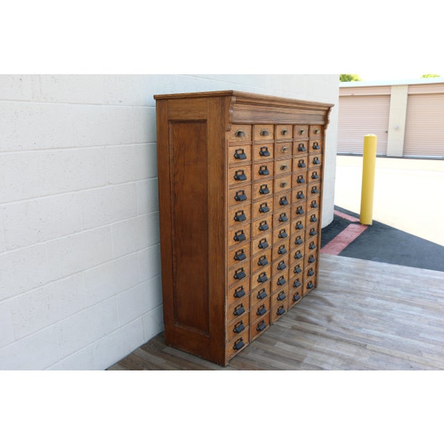 An exceptional antique apothecary and workshop cabinet crafted from solid oak, featuring an impressive 60-drawer...