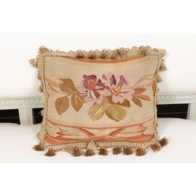 A French 19th century Aubusson tapestry pillow, with floral décor and tassels. Born during the 19th century in the...
