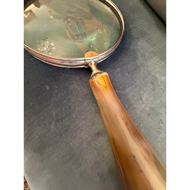 Extra large magnifying glass with horn handle. Brass finish over metal accents terminating at the edge of the handle with...