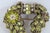 This gorgeous brooch pin is made of metal, rhinestones, and faux seed pearls. It is marked on the back as having been made...