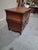 A handsome late 18th-century French Provincial walnut commode featuring elegant bombé sides, serpentine drawer fronts, and...