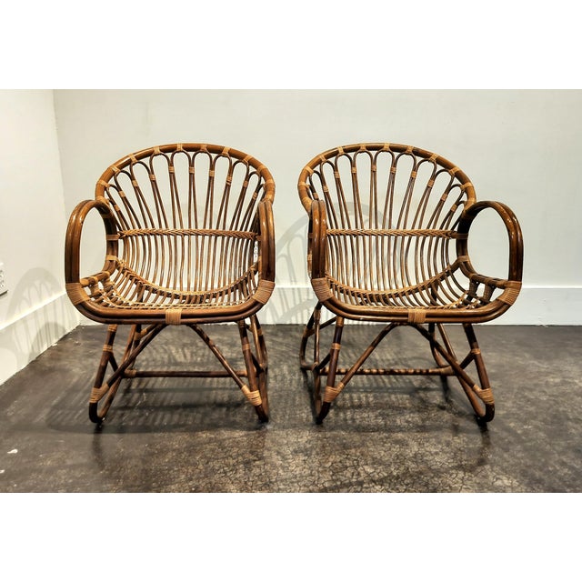 Elegant looping design chairs by Franco Albini, made of bent rattan. Chairs manufactured circa 1970s, In very good...