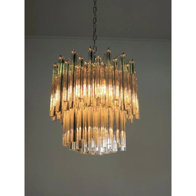 Fantastic vintage murano chandelier made by 107 murano crystal prism "triedri" in a nickel metal frame. The glasses are...