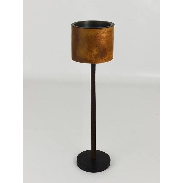 A rare Mid-Century candleholder from the 1950s by Carl Auböck. It is completely handmade and has a cylindrical top, made...