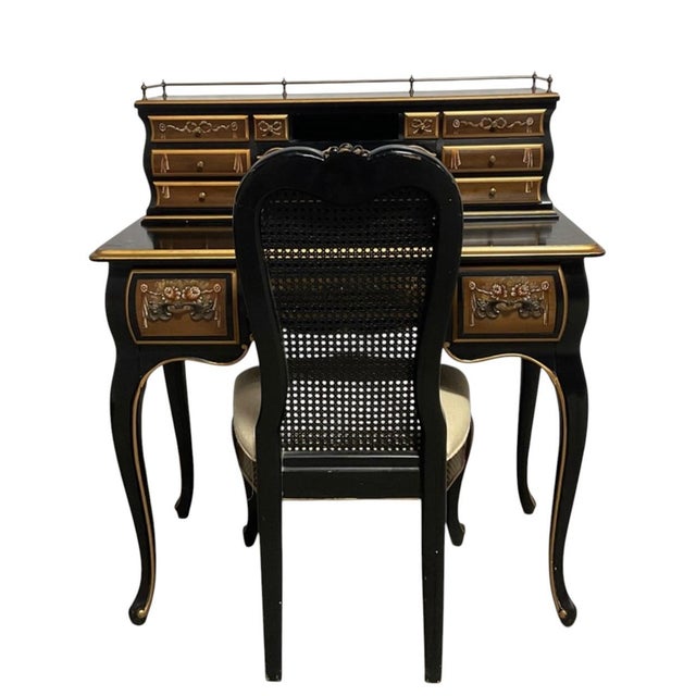Chinoiserie-Style Black Lacquer Harpsichord Desk and Matching Cane Back Chair. It features intricate gold-painted...