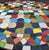 Beautiful round mosaic tile table featuring a vibrant multicolor tiled top and durable black wrought-iron style base. The...
