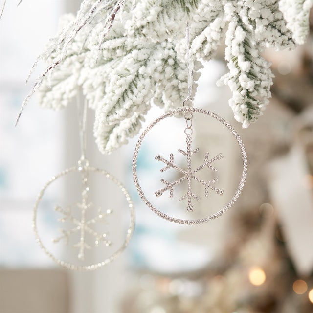 Bring glamorous holiday cheer to your tree with the Jeweled Metal Hanging Snowflake Ornament. Featuring festive silver...