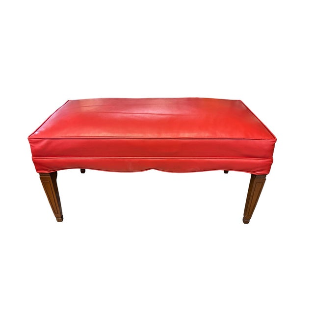 Add a bold pop of color with this vintage upholstered bench featuring a warm walnut frame and vibrant red vinyl cushion....