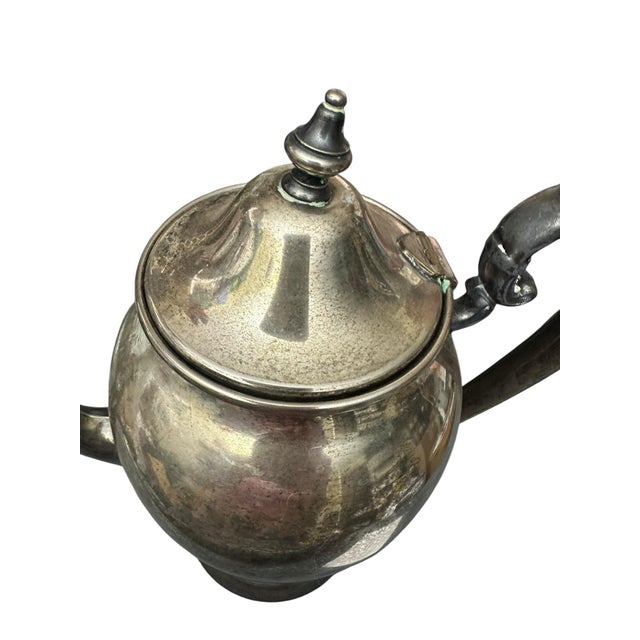 Vintage silver plated teapot, likely a Puritan style pattern with a reinforced handle, featuring a total volume of...