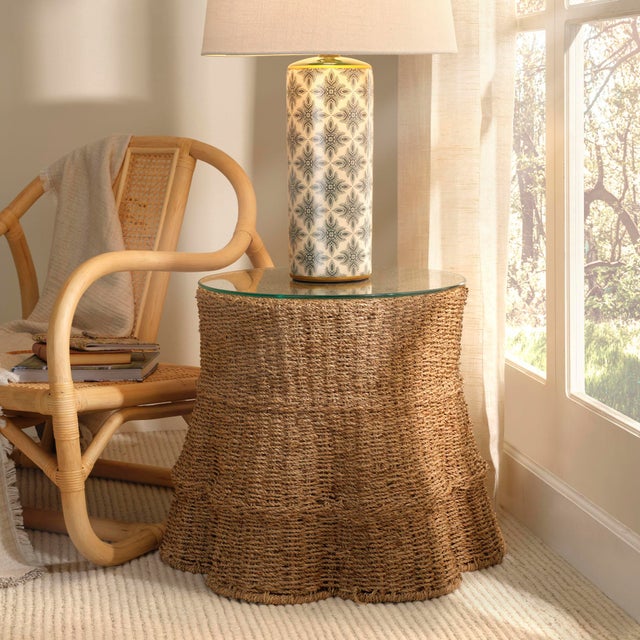 A tablecloth of rigid, hand-woven seagrass is draped over a strong metal frame to create this uniquely decorative accent...