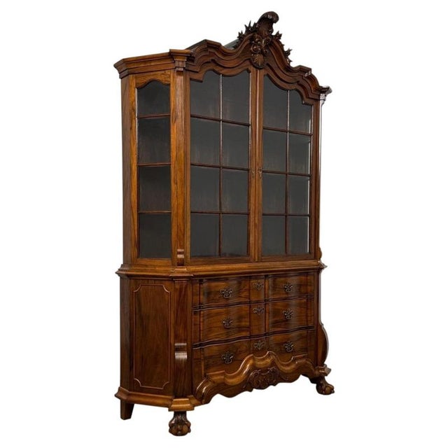 An exceptional and highly decorative 20th-century Dutch walnut display cabinet, displaying remarkable craftsmanship,...