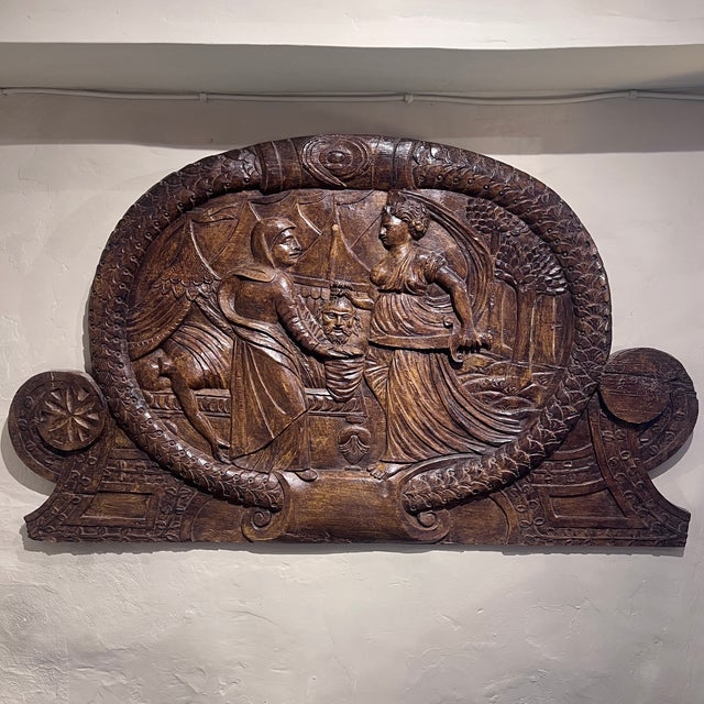 A powerful biblical relief carving showing Judith with the head of Holofernes, worked in what appears to be limewood...