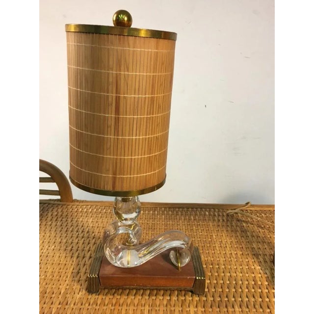 Elegant Pair of Baccarat Style Ball and Scroll form glass lamps mounted on a wood base with Brass Frames and Brass...