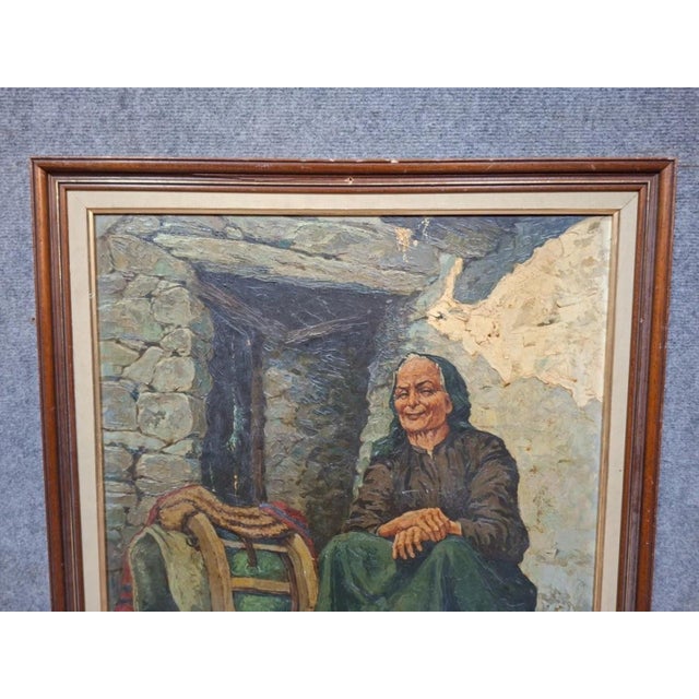 Attributed to Giulio Vittini (1888–1968), this oil on canvas depicts a genre scene featuring an elderly woman. Seated in a...