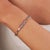 This tennis bracelet features 10.97 carats of natural mixed shape natural multicolor sapphires, set in 18K white gold....