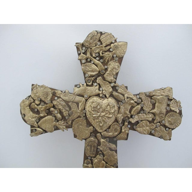 Stunning hand crafted Mexican folk art Milagros cross. Thick hand carved dark wood heavily embellished with gold tone...