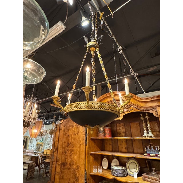 The Late 19th c. French Empire Bronze Chandelier is a stunning and elegant ceiling fixture . Featuring ornate detailing...