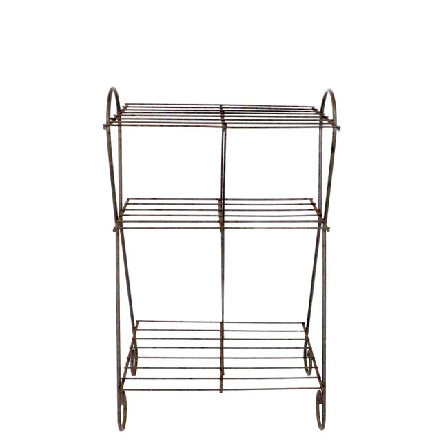 Three tier Mid Century wrought iron, wire plant stand, shelf unit. The stand is in good, original condition, showing only...