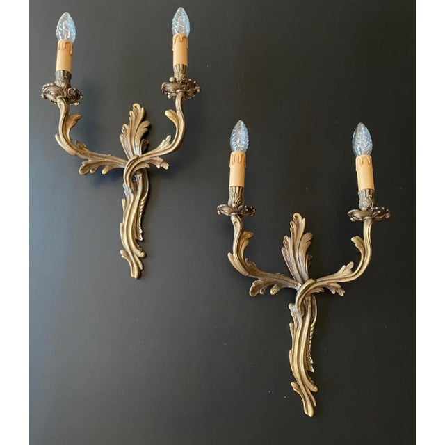 A magnificent pair of antique wall lights. italy, 20th century. the wall lights are made of bronze - luxurious artistic...