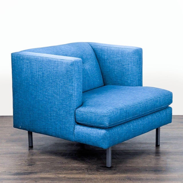 This CB2 lounge chair features a bold blue fabric and modern design. The chair offers deep, comfortable seating and...