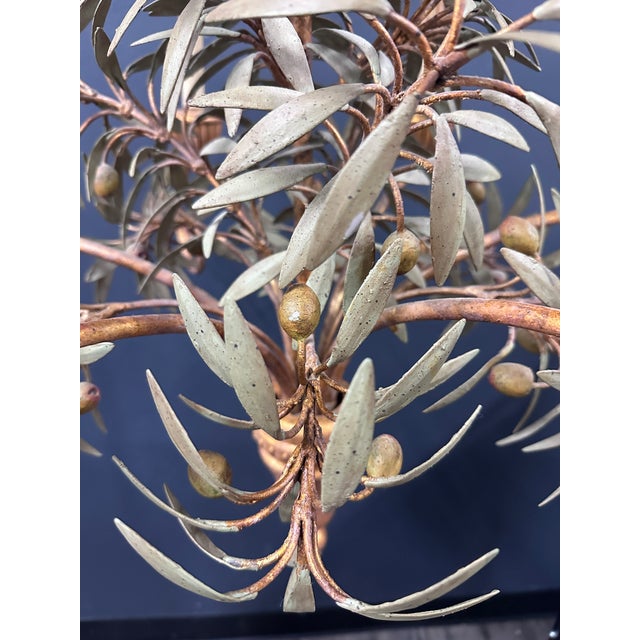 A striking vintage tole chandelier featuring a sculptural central olive branch adorned with beautifully rendered,...