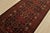 An authentic vintage tribal Baloch runner hand-knotted with fine wool and natural dyes. This nomadic rug features...