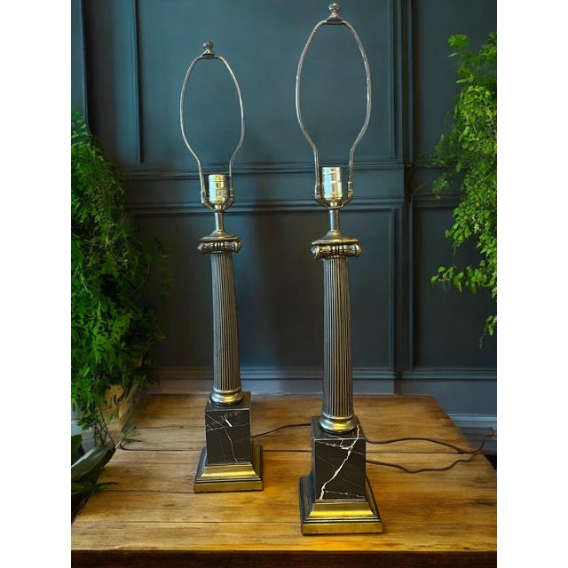 Beautiful large (35.5” H ) neoclassical ionic column table lamps with black Italian marble block bases. Reeded brass...