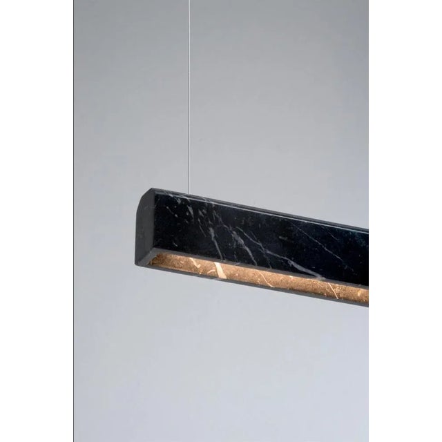 Nero marquina poem suspended light by lexavala dimensions: w 150 x d 4 (aprox) x h 4.5 cm materials: marble also available...