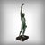 A superb Art Deco spelter sculpture with a green patina, depicting a male athlete in a victorious and elegant pose. The...