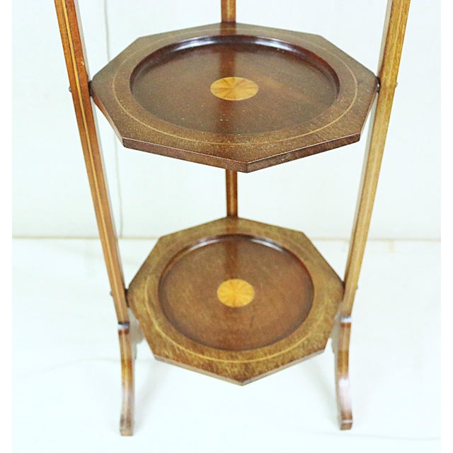 An Edwardian period folding cake stand made in England at the beginning of the 20th century. It is made of mahogany with...