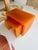 These are handcrafted nesting tables with a sleek, minimalist design. Made from a translucent orange material, they...