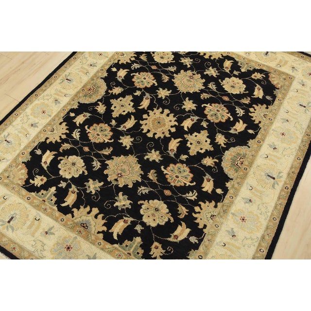 A traditional Ziegler rug hand-knotted with fine wool on a cotton foundation. This rug features an all-over botanical...