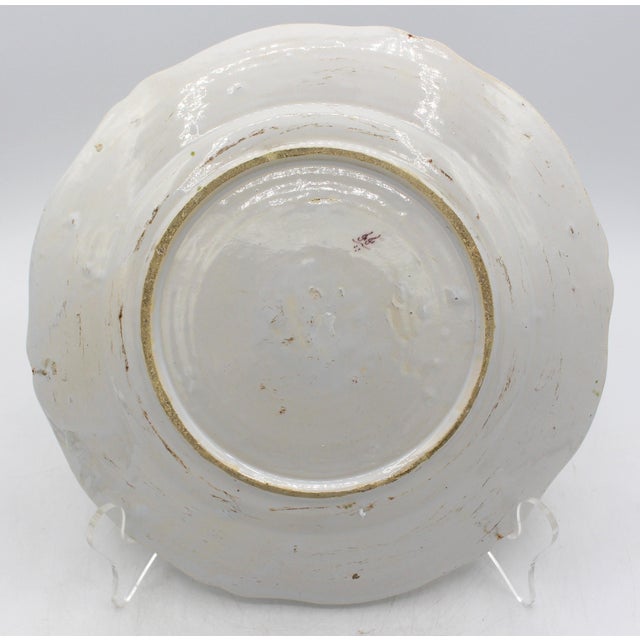 Early 19th century French faience armorial plate. Color palette typical of Rouen pieces. Scalloped edge in the style of...