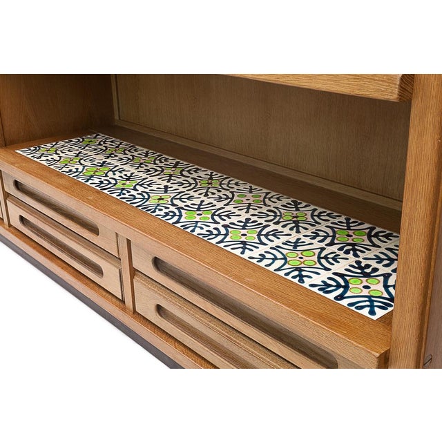 Oak wardrobe, "Gemini" model by Guillerme and Chambron, for "Votre Maison". 6 drawers. 7 shelves. Two sliding doors and a...