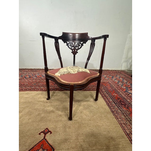Delightfully unique, this antique corner chair is a charming accent with timeless appeal. Featuring a graceful curved back...
