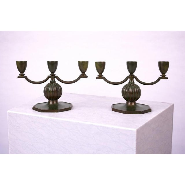 An exceptional and rare pair of swedish art deco three-arm candelabras designed by jacob ängman for gab...